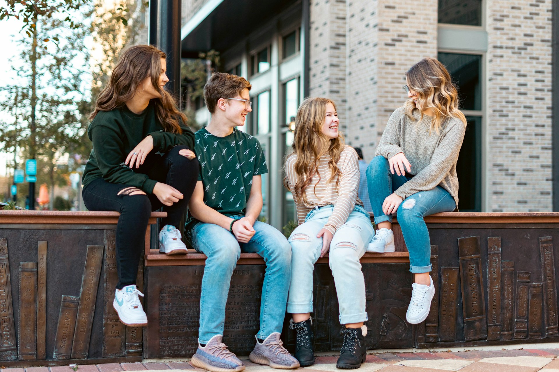 a group of young women sitting on a bench